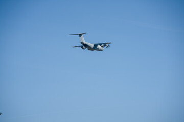 RAF Airbus C.1 A400M Atlas military transport aircraft in flight on a low-level cargo drop run, blue sky