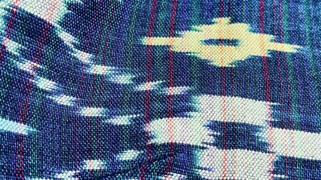 Handwoven ikat textile featuring colorful geometric patterns. Perfect for backgrounds, fashion, interior design, and cultural themes.