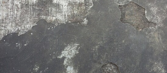 Aged and peeling paint on a textured concrete surface