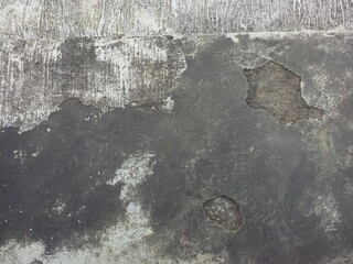 Aged and peeling paint on a textured concrete surface