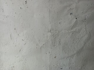 Chipped and peeling paint on a textured wall