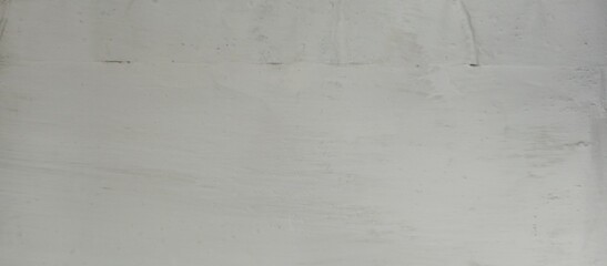Gray concrete wall with weathered and rugged texture