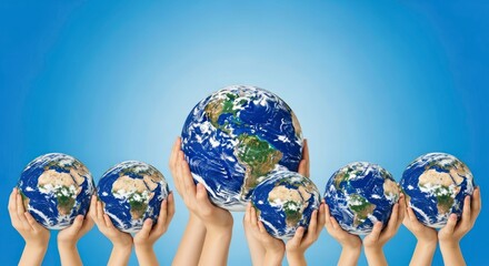 Multiple hands cradle Earth globes against a blue sky, symbolizing global unity, environmental protection, and shared responsibility for our planet.