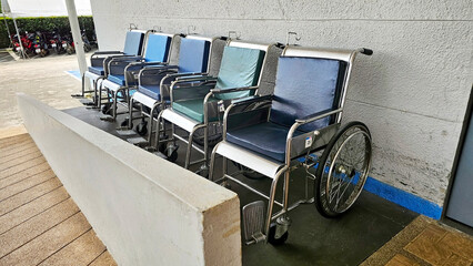 Wheelchair Line: A row of unoccupied wheelchairs neatly arranged, offering a glimpse into themes of...