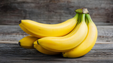 木目のテーブルに置かれたバナナの房と自然な背景