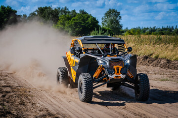 ATV, UTV, buggy, rally riding in dusty track. Amateur competitions