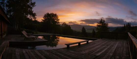 Stunning sunset view with a swimming pool on a wooden deck