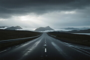 A long road stretching under a cloudy sky with distant mountains