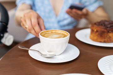 Woman drinking morning coffee from beautiful white cup