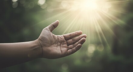 Hand reaching for light evoking spirituality and connection to the divine