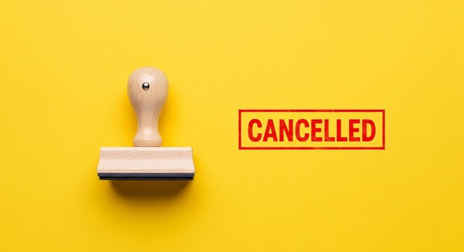 Cancelled Stamp: A wooden stamp prominently displays the word Cancelled in red letters, emphasizing a moment of administrative cessation. It is a symbolic representation of discontinuation. 