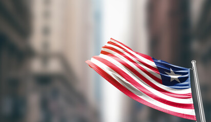 Liberia  national flag waving on street. A beautiful with mast with blur buildings. Liberia...