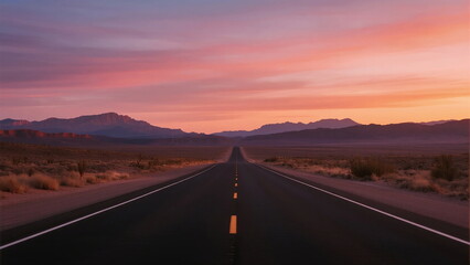 Fototapeta premium A Long Empty Road Stretching Under a Colorful Sunset Sky