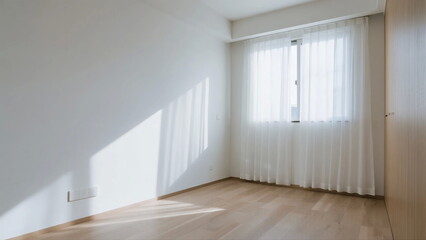 Empty room with white walls and wooden floor near window