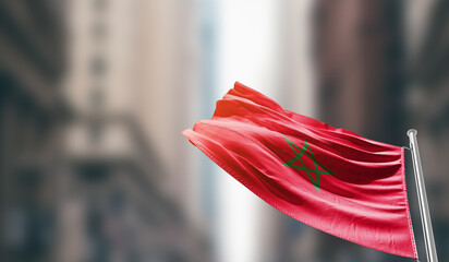 Morocco national flag waving on street. A beautiful with mast with blur buildings. Morocco national...