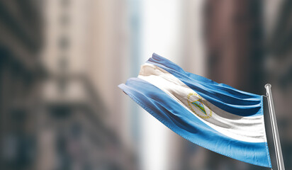 Nicaragua national flag waving on street. A beautiful with mast with blur buildings. Nicaragua...