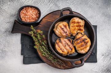 Juicy grilled pork medallions steaks, perfectly seared tenderloin meat for a flavorful bite, ideal for any gourmet meal. grey background. top view