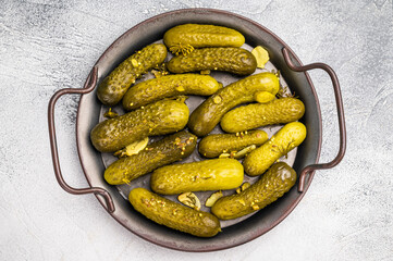 Freshly jarred dill pickles, a delightful addition to any meal or charcuterie board that adds a zesty crunch. grey background. top view