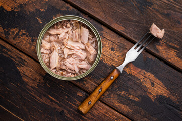Freshly opened tinned canned tuna, showcasing its rich texture and flavor, a must-have for any pantry. isolated on white background. top view