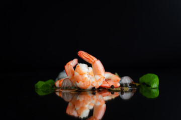 Appetizing shrimp with spices on a black background studio
