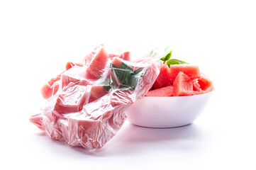 cubes of frozen watermelon in a vacuum bag on a white background
