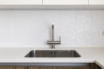kitchen faucet on a stylish metal sink