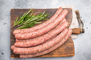 Freshly made raw sausage displayed elegantly, perfect for gourmet cooking or casual gatherings with friends. grey background. top view