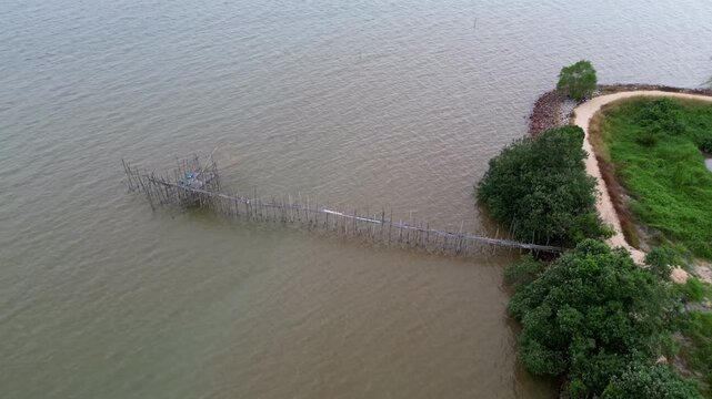 Traditional langgai which is fishing platform. The water is brown and murky. The bridge is wooden. Aerial view Pantai Parit Hailam, Batu Pahat