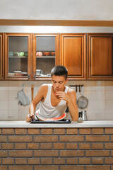 Adolescent Male Enjoying a Nutritious Snack in a Bright Dining Room.