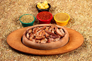 a beautiful picture of kokorech served with spices in clay pot