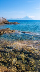 Rocky Coastline with Clear Water and Summer Sky in Greece
