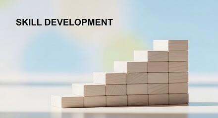 Stacked wooden blocks form a staircase representing skill development against a blurred blue background.