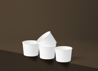 Four white 260 cc paper cups, three in a row with one placed on top of the one in the middle, resting on the edge of a brown surface.