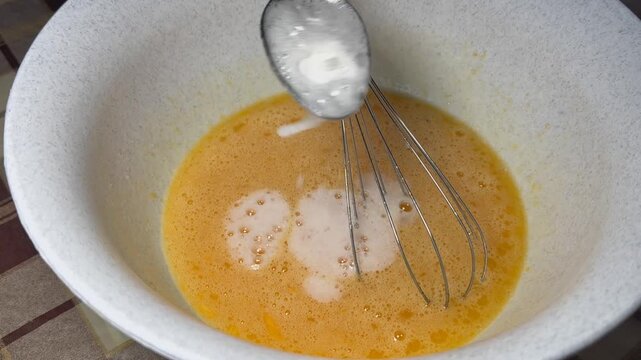 Baking process: eggs mixed with sugar, adding baking soda quenched with vinegar &mdash; culinary footage for recipes, blogs, food product ads, and educational content