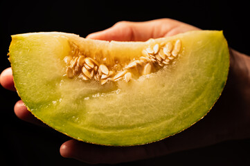 Slice of Yellow Melon on Dark Background