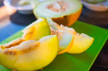 Fresh Yellow Melon Sliced on Kitchen Table
