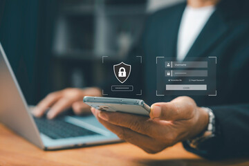 Businessman using smartphone and laptop with virtual login screen, cybersecurity protection, data privacy, secure access, and online password authentication technology.