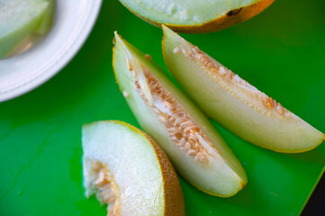 Fresh Yellow Melon Sliced on Kitchen Table