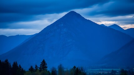 quiet. A majestic mountain silhouette against a twilight sky, radiating calm and natural beauty. travel magazines, destination branding, designed for outdoor magazines and nature guides.
