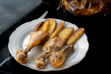 Baked Chicken Drumsticks with Potatoes on Plate