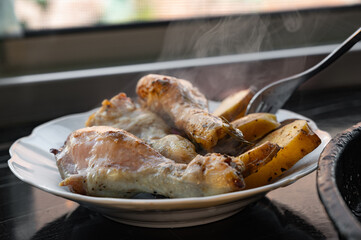 Baked Chicken Drumsticks with Potatoes on Plate