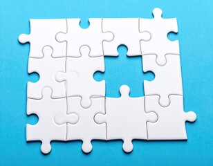 Fototapeta premium White jigsaw puzzle with a missing piece on a light-blue surface