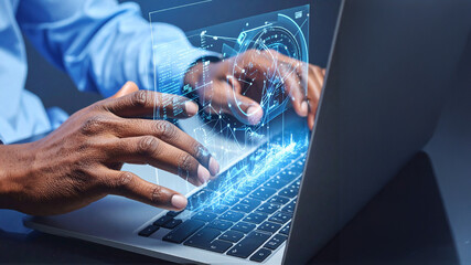 A close-up of a person's hands typing on a laptop with an illuminated, holographic interface projected above the keyboard, representing AI, data, and digital innovation.