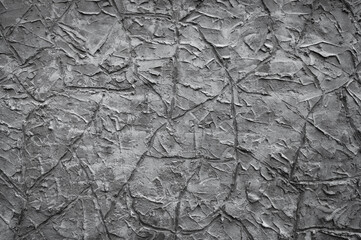 gray background, in the photo the texture of a gray wall with various lines, strokes and cracks