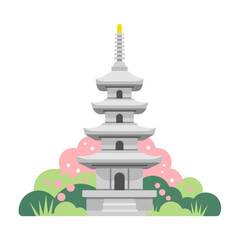 緑とピンクの花がある庭の石塔