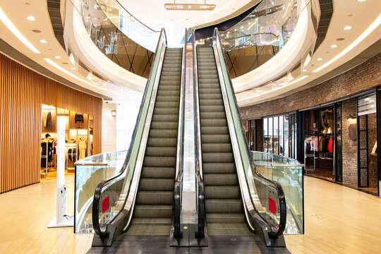 Modern luxury escalators with staircase at airport or tall building, shopping mall. Convenience of going up to next floor of building. Automatic movement technology and beautiful interior decoration.