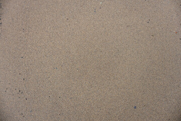 Natural sand texture background with fine grains, top view. Minimal natural backdrop for summer, beach, desert, or abstract design concepts