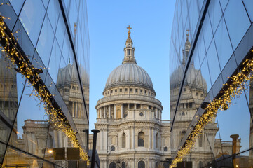 Breathtaking sunrise over Saint Paul Cathedral in London with reflections and holiday lights