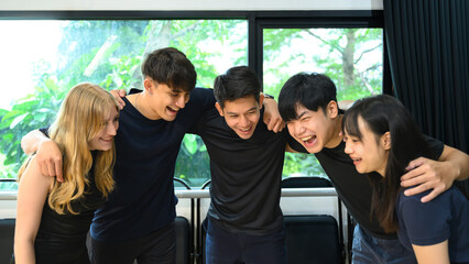 Diverse group of young adults smiling and bonding together after a fitness workout session