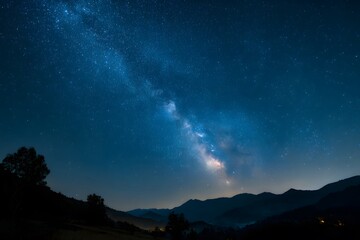 Starry night sky over mountains.